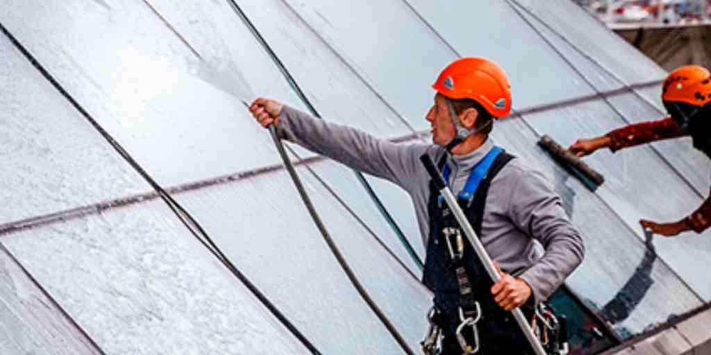 Before – rope access technicians cleaning sloped glass roof