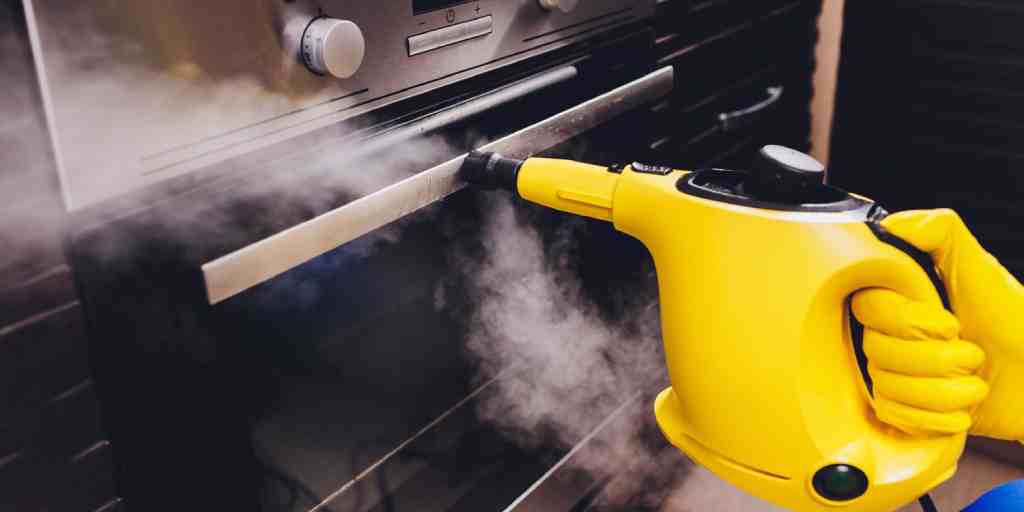 Before – commercial kitchen oven being steam cleaned