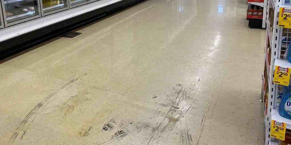 Before – fridge and freezer aisle vinyl floor scuffed and worn